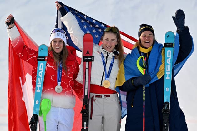 Cortina d Ampezzo, Italy, February 18th 2026. First place and Gold medal Mikaela Shiffrin of United States of America (C), Second place and Silver medal Camille Rast of Switzerland (L) and Third place and Bronze medal Anna Swenn Larsson of Sweden (R) celebrate in podium after the Alpine Skiing Womens Slalom race of the Olympic Winter games, Winterspiele,Spiele, Summer games 2026 in Cortina d Ampezzo, Italy. (Photo by Igor Kupljenik Sports Press Photo)  Copyright: xIgorxKupljenikx xSPPx Sportspressphoto_SPR94112