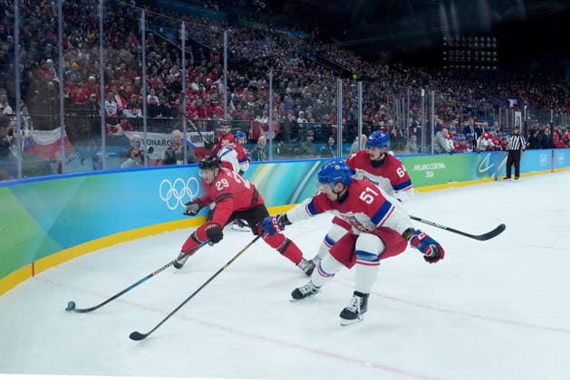 February 18, 2026, Milan, ITALY: Canada s Nathan MacKinnon (29) and Czechia s Radim Simek (51) battle for the puck during the first period of a quarterfinal men s hockey game at the 2026 Winter Olympics, in Milan, on Wednesday, Feb. 18, 2026. Canada News - February 18, 2026  - ZUMAc35_ 20260218_zaf_c35_078 Copyright: xDarrylxDyckx