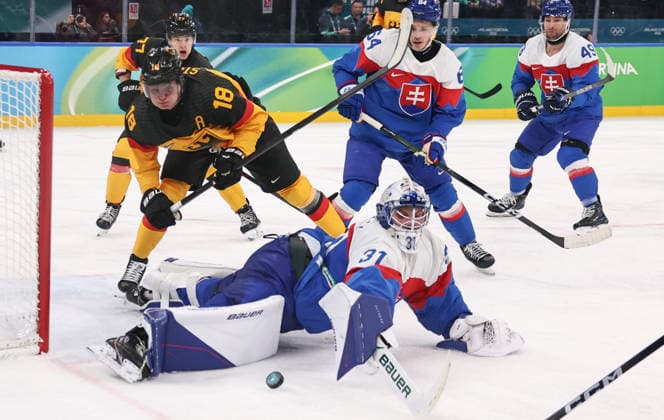 (260218) -- MILAN, Feb. 18, 2026 -- Goalkeeper Samuel Hlavaj (bottom) of Slovakia saves the puck during the Ice hockey, Eishockey men s play-offs quarterfinal between the Slovakia and Germany at the Milan-Cortina 2026 Olympic Winter games, Winterspiele,Spiele, Summer games in Milan, Italy, Feb. 18, 2026. ) (MICO2026)ITALY-MILAN-OLYMPIC WINTER GAMES-ICE HOCKEY-MEN-PLAY-OFFS QUARTERFINALS-SVK VS GER WangxKaiyan 