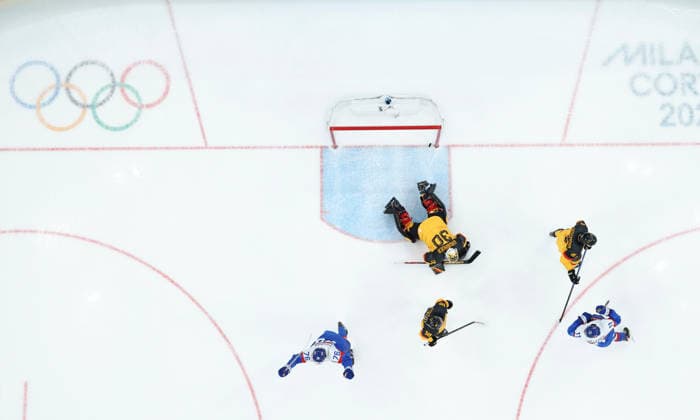 (260218) -- MILAN, Feb. 18, 2026 -- Goalkeeper Philipp Grubauer (top) of Germany fails to save the puck during the Ice hockey, Eishockey men s play-offs quarterfinal between the Slovakia and Germany at the Milan-Cortina 2026 Olympic Winter games, Winterspiele,Spiele, Summer games in Milan, Italy, Feb. 18, 2026. ) (MICO2026)ITALY-MILAN-OLYMPIC WINTER GAMES-ICE HOCKEY-MEN-PLAY-OFFS QUARTERFINALS-SVK VS GER WangxKaiyan 