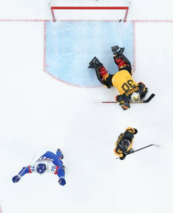 (260218) -- MILAN, Feb. 18, 2026 -- Goalkeeper Philipp Grubauer (top) of Germany fails to save the puck during the Ice hockey, Eishockey men s play-offs quarterfinal between the Slovakia and Germany at the Milan-Cortina 2026 Olympic Winter games, Winterspiele,Spiele, Summer games in Milan, Italy, Feb. 18, 2026. ) (MICO2026)ITALY-MILAN-OLYMPIC WINTER GAMES-ICE HOCKEY-MEN-PLAY-OFFS QUARTERFINALS-SVK VS GER WangxKaiyan 