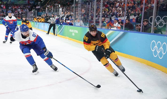(260218) -- MILAN, Feb. 18, 2026 -- Frederik Tiffels (R) of Germany vies with Erik Cernak of Slovakia during the Ice hockey, Eishockey men s play-offs quarterfinal between the Slovakia and Germany at the Milan-Cortina 2026 Olympic Winter games, Winterspiele,Spiele, Summer games in Milan, Italy, Feb. 18, 2026. ) (MICO2026)ITALY-MILAN-OLYMPIC WINTER GAMES-ICE HOCKEY-MEN-PLAY-OFFS QUARTERFINALS-SVK VS GER WangxKaiyan 