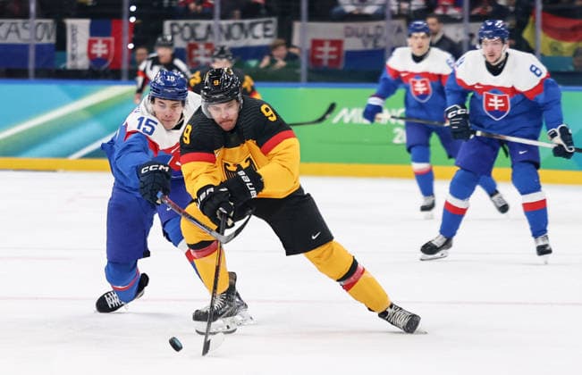 (260218) -- MILAN, Feb. 18, 2026 -- Leon Gawanke (R, front) of Germany vies with Dalibor Dvorsky of Slovakia during the Ice hockey, Eishockey men s play-offs quarterfinal between the Slovakia and Germany at the Milan-Cortina 2026 Olympic Winter games, Winterspiele,Spiele, Summer games in Milan, Italy, Feb. 18, 2026. ) (MICO2026)ITALY-MILAN-OLYMPIC WINTER GAMES-ICE HOCKEY-MEN-PLAY-OFFS QUARTERFINALS-SVK VS GER WangxKaiyan 
