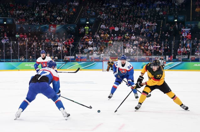 (260218) -- MILAN, Feb. 18, 2026 -- John Peterka (1st R) of Germany shoots during the Ice hockey, Eishockey men s play-offs quarterfinal between the Slovakia and Germany at the Milan-Cortina 2026 Olympic Winter games, Winterspiele,Spiele, Summer games in Milan, Italy, Feb. 18, 2026. ) (MICO2026)ITALY-MILAN-OLYMPIC WINTER GAMES-ICE HOCKEY-MEN-PLAY-OFFS QUARTERFINALS-SVK VS GER WangxKaiyan 