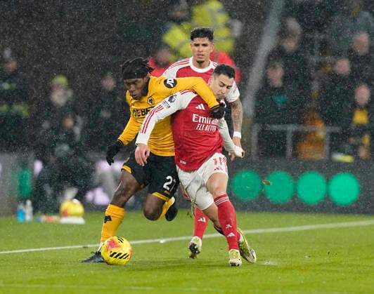 Wolverhampton, England, 18th February 2026. Jean-Ricner Bellegarde of Wolverhampton Wanderers tussles with Gabriel Martinelli of Arsenal during the Wolverhampton Wanderers vs Arsenal Premier League match at Molineux, Wolverhampton. Picture credit should read: Andrew Yates Sportimage EDITORIAL USE ONLY. No use with unauthorised audio, video, data, fixture lists, club league logos or live services. Online in-match use limited to 120 images, no video emulation. No use in betting, games or single club league player publications. SPI_028_AY_Wolves_Arsenal SPI-4539-0030