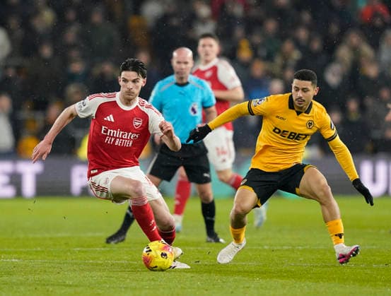 Wolverhampton, England, 18th February 2026. Declan Rice of Arsenal and Andre of Wolverhampton Wanderers during the Wolverhampton Wanderers vs Arsenal Premier League match at Molineux, Wolverhampton. Picture credit should read: Andrew Yates Sportimage EDITORIAL USE ONLY. No use with unauthorised audio, video, data, fixture lists, club league logos or live services. Online in-match use limited to 120 images, no video emulation. No use in betting, games or single club league player publications. SPI_032_AY_Wolves_Arsenal SPI-4539-0034