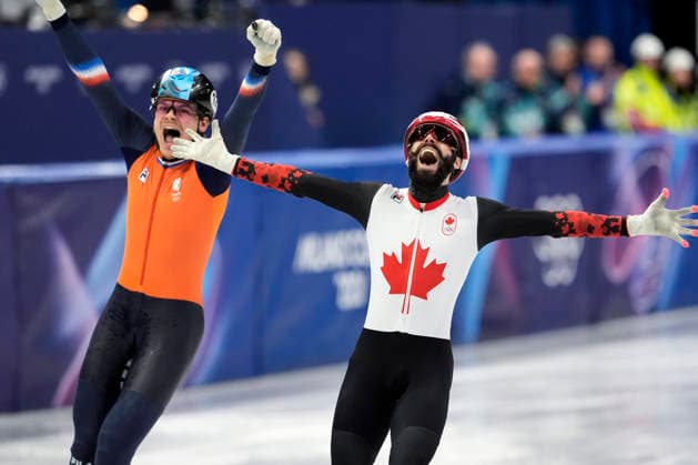 Steven Dubois, 4, of Canada and Melle van t Wout, 121, of Netherlands celebrate after winning gold and silver during during the Men s Short Track Speed skating, Eisschnelllauf 500m Finals at the Milano Figure skating, Eiskunstlauf Arena in Milan, Italy on Wednesday, February 18, 2026. Melle s brother, Jens van t Wout, 2, of Netherlands won bronze.  OLY20260218134 RICHARDxELLIS