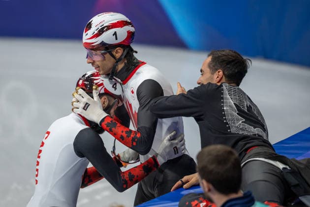 February 18, 2026, Milano, Lombardy, Italy: Steven Dubois (4) of Canada is congratulated by William Dandjinou (1) of Canada as he celebrates winning the gold medal in the Short Track Speed skating, Eisschnelllauf Men 500m Final during the 2026 Winter Olympics at the Milano Ice Skating Arena on Wednesday in Milano. Milano Italy - ZUMAj89_ 20260218_oly_j89_010 Copyright: xPaulxKitagakixJr.x