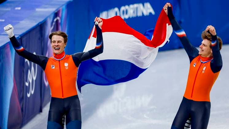 third Jens van t Wout of the Netherlands and second Melle van t Wout of the Netherlands celebrating and holding flag after Men s 500m Finals, Milano Cortina 2026 Winter Olympics: Day 12, Short Track Speed skating, Eisschnelllauf - Milano Cortina 2026 Winter Olympics: Day 12, Milano Speed Skating Stadium, February 18, 2026, Milan, Italy.