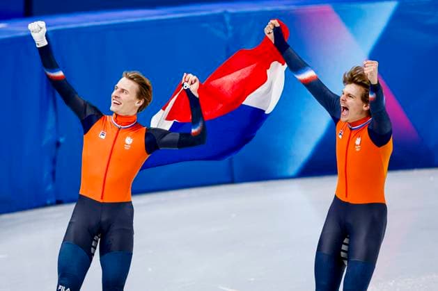 third Jens van t Wout of the Netherlands and second Melle van t Wout of the Netherlands celebrating and holding flag after Men s 500m Finals, Milano Cortina 2026 Winter Olympics: Day 12, Short Track Speed skating, Eisschnelllauf - Milano Cortina 2026 Winter Olympics: Day 12, Milano Speed Skating Stadium, February 18, 2026, Milan, Italy.
