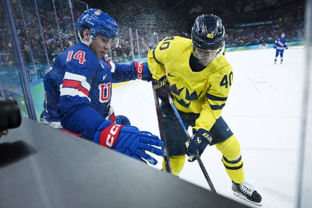 (260219) -- MILAN, Feb. 19, 2026 -- Sweden s Elias Pettersson (R) fights for the puck against Brock Faber of the United States during the Ice hockey, Eishockey men s play-offs quarterfinal between Sweden and the United States at the Milan-Cortina 2026 Olympic Winter games, Winterspiele,Spiele, Summer games in Milan, Italy, Feb. 18, 2026. ) (MICO2026)ITALY-MILAN-OLYMPIC WINTER GAMES-ICE HOCKEY-MEN-PLAY-OFFS QUARTERFINALS-SWE VS USA ZhangxHaofu 