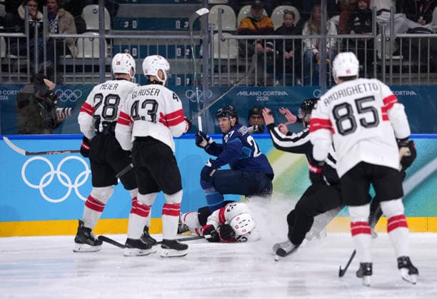 (260219) -- MILAN, Feb. 19, 2026 -- Switzerland s Nico Hischier (bottom) falls down during the Ice hockey, Eishockey men s play-offs quarterfinal between Finland and Switzerland at the Milan-Cortina 2026 Olympic Winter games, Winterspiele,Spiele, Summer games in Milan, Italy, Feb. 18, 2026. ) (MICO2026)ITALY-MILAN-OLYMPIC WINTER GAMES-ICE HOCKEY-MEN-PLAY-OFFS QUARTERFINALS-FIN VS SUI TaoxXiyi 