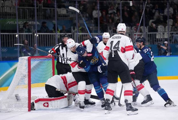 (260219) -- MILAN, Feb. 19, 2026 -- Players of both teams compete during the Ice hockey, Eishockey men s play-offs quarterfinal between Finland and Switzerland at the Milan-Cortina 2026 Olympic Winter games, Winterspiele,Spiele, Summer games in Milan, Italy, Feb. 18, 2026. ) (MICO2026)ITALY-MILAN-OLYMPIC WINTER GAMES-ICE HOCKEY-MEN-PLAY-OFFS QUARTERFINALS-FIN VS SUI TaoxXiyi 