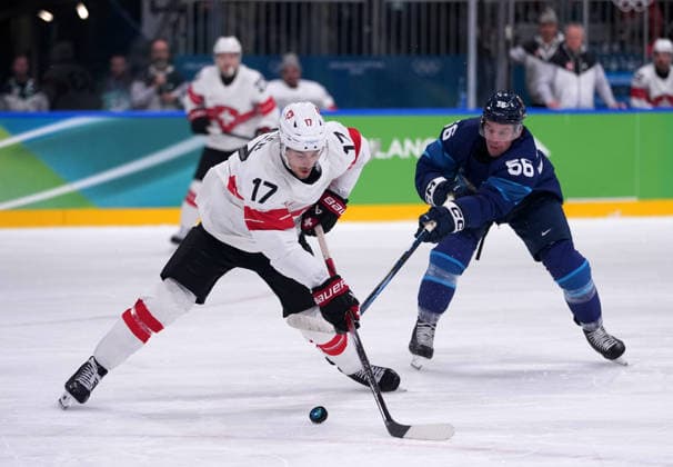 (260219) -- MILAN, Feb. 19, 2026 -- Ken Jager (L) of Switzerland fights for the puck against Erik Haula of Finland during the Ice hockey, Eishockey men s play-offs quarterfinal between Finland and Switzerland at the Milan-Cortina 2026 Olympic Winter games, Winterspiele,Spiele, Summer games in Milan, Italy, Feb. 18, 2026. ) (MICO2026)ITALY-MILAN-OLYMPIC WINTER GAMES-ICE HOCKEY-MEN-PLAY-OFFS QUARTERFINALS-FIN VS SUI TaoxXiyi 