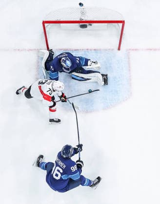 (260219) -- MILAN, Feb. 19, 2026 -- Sandro Schmid (C) of Switzerland shoots during the Ice hockey, Eishockey men s play-offs quarterfinal between Finland and Switzerland at the Milan-Cortina 2026 Olympic Winter games, Winterspiele,Spiele, Summer games in Milan, Italy, Feb. 18, 2026. ) (MICO2026)ITALY-MILAN-OLYMPIC WINTER GAMES-ICE HOCKEY-MEN-PLAY-OFFS QUARTERFINALS-FIN VS SUI SunxFei 