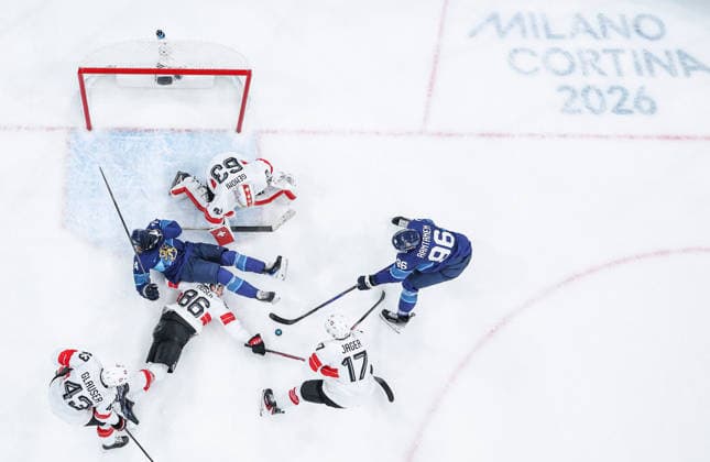 (260219) -- MILAN, Feb. 19, 2026 -- Players of both teams compete during the Ice hockey, Eishockey men s play-offs quarterfinal between Finland and Switzerland at the Milan-Cortina 2026 Olympic Winter games, Winterspiele,Spiele, Summer games in Milan, Italy, Feb. 18, 2026. ) (MICO2026)ITALY-MILAN-OLYMPIC WINTER GAMES-ICE HOCKEY-MEN-PLAY-OFFS QUARTERFINALS-FIN VS SUI SunxFei 