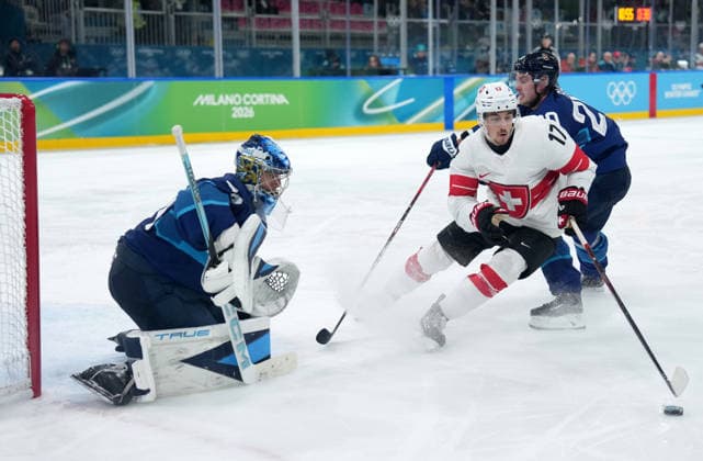 (260219) -- MILAN, Feb. 19, 2026 -- Ken Jager (C) of Switzerland vies for the puck during the Ice hockey, Eishockey men s play-offs quarterfinal between Finland and Switzerland at the Milan-Cortina 2026 Olympic Winter games, Winterspiele,Spiele, Summer games in Milan, Italy, Feb. 18, 2026. ) (MICO2026)ITALY-MILAN-OLYMPIC WINTER GAMES-ICE HOCKEY-MEN-PLAY-OFFS QUARTERFINALS-FIN VS SUI SunxFei 