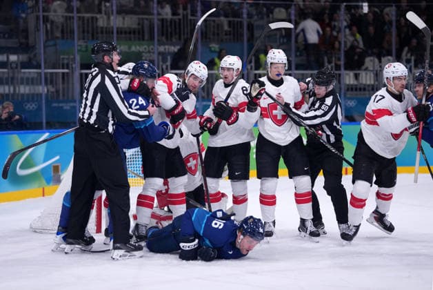 (260219) -- MILAN, Feb. 19, 2026 -- Players of both teams fight during the Ice hockey, Eishockey men s play-offs quarterfinal between Finland and Switzerland at the Milan-Cortina 2026 Olympic Winter games, Winterspiele,Spiele, Summer games in Milan, Italy, Feb. 18, 2026. ) (MICO2026)ITALY-MILAN-OLYMPIC WINTER GAMES-ICE HOCKEY-MEN-PLAY-OFFS QUARTERFINALS-FIN VS SUI TaoxXiyi 