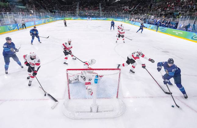 (260219) -- MILAN, Feb. 19, 2026 -- Players of both teams compete during the Ice hockey, Eishockey men s play-offs quarterfinal between Finland and Switzerland at the Milan-Cortina 2026 Olympic Winter games, Winterspiele,Spiele, Summer games in Milan, Italy, Feb. 18, 2026. ) (MICO2026)ITALY-MILAN-OLYMPIC WINTER GAMES-ICE HOCKEY-MEN-PLAY-OFFS QUARTERFINALS-FIN VS SUI SunxFei 