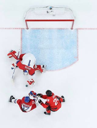 (260219) -- MILAN, Feb. 19, 2026 -- Lukas Dostal (top), goalkeeper of the Czech Republic, makes a save during the Ice hockey, Eishockey men s play-offs quarterfinals match between Canada and the Czech Republic at the Milan-Cortina 2026 Olympic Winter games, Winterspiele,Spiele, Summer games in Milan, Italy, Feb. 18, 2026. ) (MICO2026)ITALY-MILAN-OLYMPIC WINTER GAMES-ICE HOCKEY-MEN-PLAY-OFFS QUARTERFINALS-CAN VS CZE ZhangxHaofu 