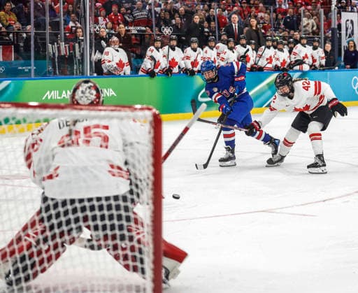 United States Abbey Murphy (37) takes a shot on Canada s Ann-Renee Desbiens (35) as Canada s Claire Thompson (42) defends in the first period of the Women s Hockey Gold Medal Game between Canada and the USA at the Milano Santagiulia Ice hockey, Eishockey Arena in Milan, Italy, on Thursday, February 19, 2026.  OLY20260219307 AARONxJOSEFCZYK