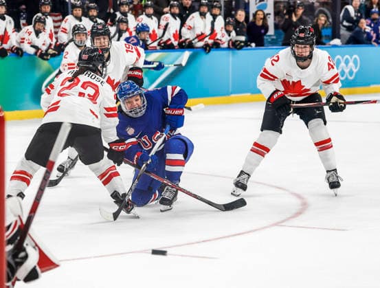 United States Cayla Barnes (3) shoots on goal between Canada s Erin Ambrose (23) and Canada s Claire Thompson (42) in the first period of the Women s Hockey Gold Medal Game between Canada and the USA at the Milano Santagiulia Ice hockey, Eishockey Arena in Milan, Italy, on Thursday, February 19, 2026.  OLY20260219311 AARONxJOSEFCZYK