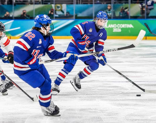 United States Tessa Janecke (22) watches as United States Megan Keller (5) moves the puck in the third period of the Gold Medal Game between Canada and the USA at the Milano Santagiulia Ice hockey, Eishockey Arena in Milan, Italy, on Thursday, February 19, 2026.  OLY20260219327 AARONxJOSEFCZYK