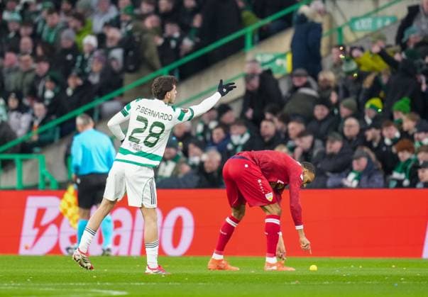 Paulo Bernardo of Celtic removes balls thrown on to the pitch by Celtic fans as protest against the Celtic FC board. Celtic v Stuttgart, UEFA Europa League, Knockout Round Play Offs, First Leg, Football, Celtic Park, Glasgow, Scotland, UK - 19 Feb 2026Glasgow Celtic Park Scotland United Kingdom EDITORIAL USE ONLY No use with unauthorised audio, video, data, fixture lists, club league logos or live services. Online in-match use limited to 120 images, no video emulation. No use in betting, games or single club league player publications. Copyright: xStuartxWallace Shutterstockx 16674319u