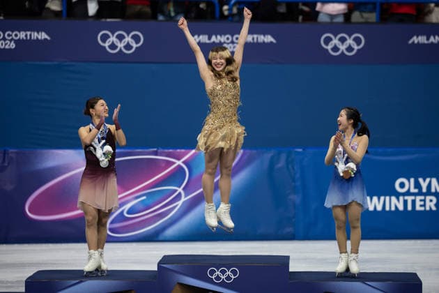 February 19, 2026, Milano, Lombardy, Italy: Gold medal winner Alysa Liu of the United States leaps on the the awards podium with Silver medal winner Kaori Sakamoto of Japan and Bronze medal winner Ami Nakai of Japan stand on the podium in Figure skating, Eiskunstlauf Women Single during the 2026 Winter Olympics at the Milano Ice Skating Arena on Thursday in Milano. Olympics 2026: Milano Cortina: Figure Skating Women s  - ZUMAj89_ 20260219_oly_j89_085 Copyright: xPaulxKitagakixJr.x