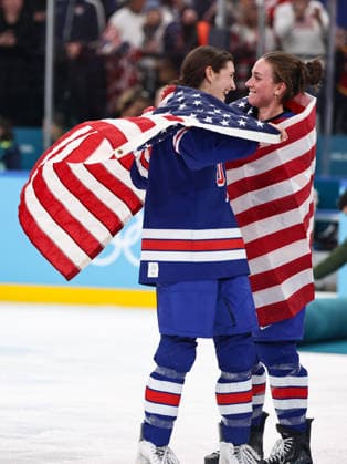 (260220) -- MILAN, Feb. 20, 2026 -- Megan Keller (L) of the United States celebrates victory after the Ice hockey, Eishockey women s gold medal game between the United States and Canada at the Milan-Cortina 2026 Olympic Winter games, Winterspiele,Spiele, Summer games in Milan, Italy, Feb. 19, 2026. ) (MICO2026)ITALY-MILAN-OLYMPIC WINTER GAMES-ICE HOCKEY-WOMEN-GOLD MEDAL GAME-USA VS CAN WangxKaiyan 