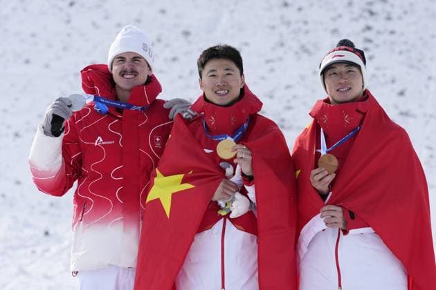 Milan Cortina Olympics: Freestyle skiing Chinese freestyle skier Wang Xindi (C) poses after winning the men s aerials gold at the Milan Cortina Olympics on Feb. 20, 2026, at Livigno Aerials &amp; Moguls Park in Livigno, Italy, alongside silver medalist Noe Roth (L) of Switzerland and bronze medalist Li Tianma of China.  A14AA0005308627P
