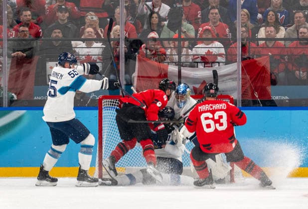February 20, 2026, Milan, Lombardy, Italy: Team Canada knocks a Finnish player into the net in the first period of their semifinals at Milano Santaguilia Ice hockey, Eishockey Arena during the Milano Cortina 2026 Winter Olympics. Olympics 2026: Milano Cortina: - February 20, 2026  - ZUMAh234 20260220_oly_h234_001 Copyright: xMarkxEdwardxHarrisx