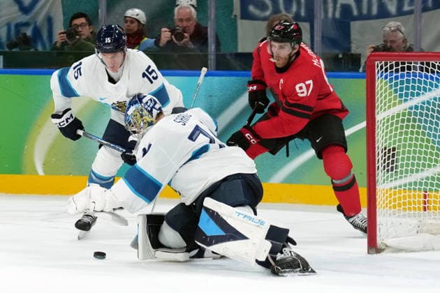 February 20, 2026, Milan, ITALY: Finland forward Anton Lundell (15) and Canada forward Connor McDavid (97) look on as Finland goaltender Juuse Saros (74) makes a save during second period Men s Olympic semifinal Ice hockey, Eishockey action at the 2026 Milan Cortina Winter Olympics in Milan, Friday, Feb. 20, 2026. Canada News - February 20, 2026  - ZUMAc35_ 20260220_zaf_c35_051 Copyright: xNathanxDenettex
