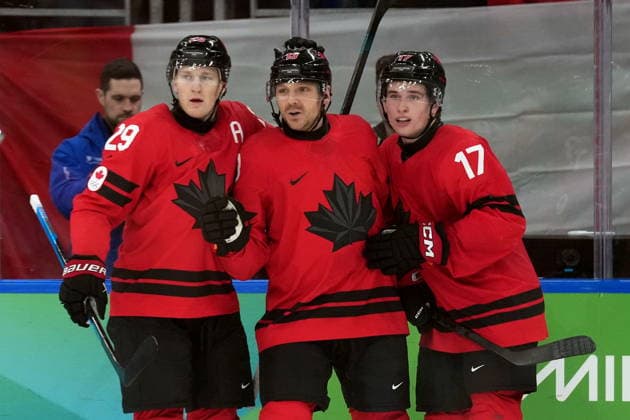 February 20, 2026, Milan, ITALY: Canada forward Sam Reinhart (13) celebrates his goal with teammates Nathan MacKinnon (29) and Macklin Celebrini (17) during second period Men s Olympic semifinal Ice hockey, Eishockey action against Finland, at the 2026 Milan Cortina Winter Olympics in Milan, Friday, Feb. 20, 2026. Canada News - February 20, 2026  - ZUMAc35_ 20260220_zaf_c35_053 Copyright: xNathanxDenettex