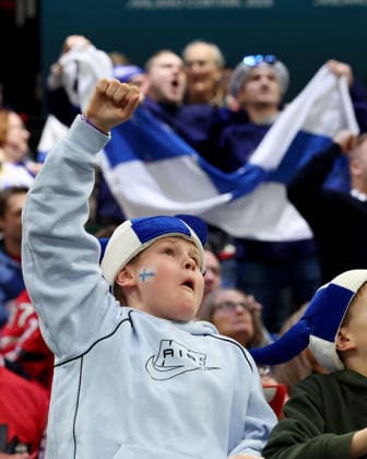February 20, 2026, Milan, Italy: Team Finland fan cheers a goal against Team Canada in a men s Ice hockey, Eishockey semifinal game during the Milano Cortina 2026 Olympic Winter games, Winterspiele,Spiele, Summer games Milan Italy - ZUMAm117 20260220_oly_m117_009 Copyright: xDavidxMcIntyrex