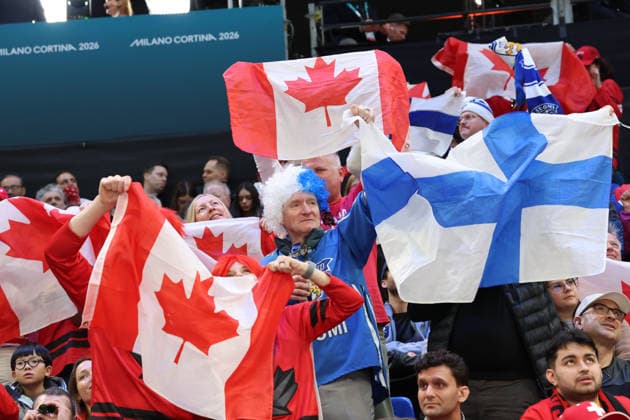 February 20, 2026, Milan, Lombardy, Italy: Team Finland fan among flags of Team Canada in a men s Ice hockey, Eishockey semifinal during the Milano Cortina 2026 Olympic Winter games, Winterspiele,Spiele, Summer games at Milano Santagiulia Ice Hockey Arena Olympics 2026: Milano Cortina: Ice Hockey-Men Semifinal- CAN-FIN  - ZUMAm117 20260220_oly_m117_018 Copyright: xDavidxMcIntyrex