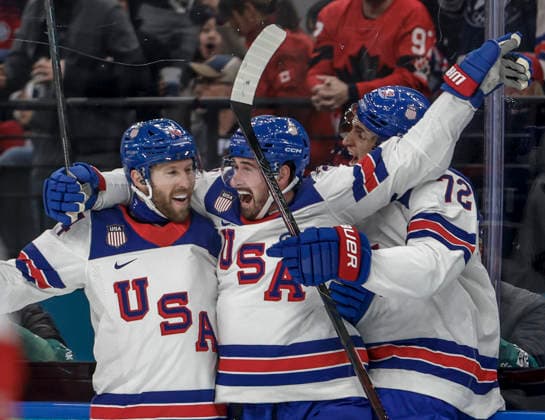 Team USA members celebrate their first goal in the first period of the Men s Hockey Play-off Semifinal game between Slovakia and the USA at the Milano Santagiulia Ice hockey, Eishockey Arena in Milan, Italy, on Friday, February 20, 2026.  OLY20260220308 AARONxJOSEFCZYK
