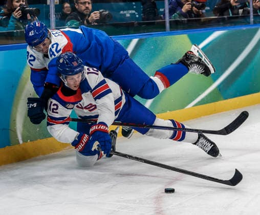 United States Matt Boldy (12) goes down under Slovakia s Martin Fehervary (42) in the second period of the Men s Hockey Play-off Semifinal game between Slovakia and the USA at the Milano Santagiulia Ice hockey, Eishockey Arena in Milan, Italy, on Friday, February 20, 2026.  OLY20260220325 AARONxJOSEFCZYK