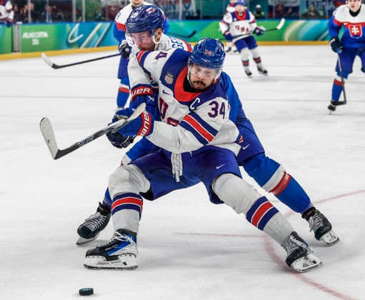 United States Auston Matthews (34) blocks Slovakia s Martin Gernat (28) from the puck in the third period of the Men s Hockey Play-off Semifinal game between Slovakia and the USA at the Milano Santagiulia Ice hockey, Eishockey Arena in Milan, Italy, on Friday, February 20, 2026.  OLY20260220334 AARONxJOSEFCZYK