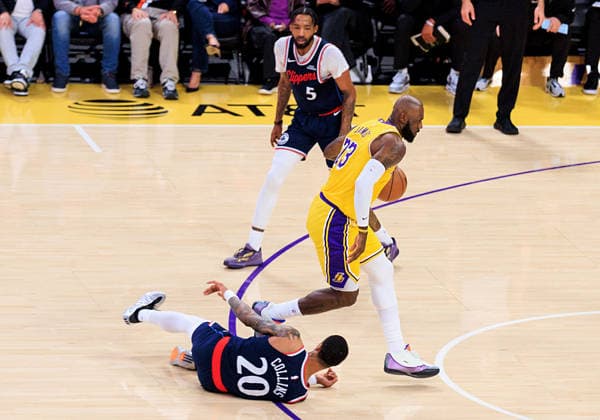 February 20, 2026, Los Angeles, California, USA: LeBron James 23 of the Los Angeles Lakers goes by John Collins 20 of the Los Angeles Clippers as he falls during a regular season NBA, Basketball Herren, USA game on Friday February 20, 2026 at Crypto.com Arena in Los Angeles, California. JAVIER ROJAS PI Los Angeles USA - ZUMAp124 20260220_zaa_p124_104 Copyright: xJavierxRojasx