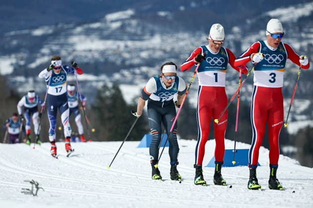 ITALY, TESERO - FEBRUARY 21, 2026: Martin Loewstroem Nyenget of Norway, Johannes Hoesflot Klaebo of Norway, AIN athlete Savelii Korostelev from Russia, and Victor Lovera (R-L) of France compete in the men s nross-nountry skiing 50km mass start classic event during the 2026 Winter Olympic Games, Olympische Spiele, Olympia, OS at the Cross-Country and Biathlon Centre Fabio Canal. Mikhail Tereshchenko TASS  89032454