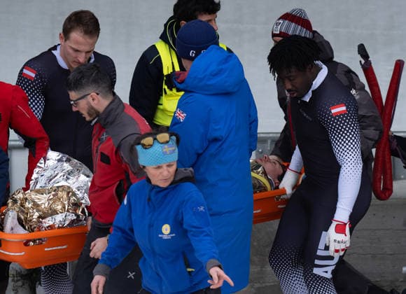 (260221) -- CORTINA D AMPEZZO, Feb. 21, 2026 -- Rescue workers and athletes of Austria carry injured athlete Jakob Mandlbauer during the Bobsleigh 4-man heat 2 at the 2026 Milan-Cortina Winter Olympics in Cortina D Ampezzo, Italy, Feb. 21, 2026. ) (MICO2026)ITALY-CORTINA D AMPEZZO-OLYMPIC Winter games, Winterspiele,Spiele, Summer games BOBSLEIGH-4-MAN FeixMaohua 