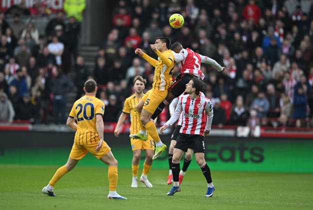 21st February 2026; Gtech Community Stadium, Brentford, London, England; Premier League Football, Brentford versus Brighton and Hove Albion; Diego Gomez of Brighton competes in the air with Rico Henry of Brentford  SimonxWest