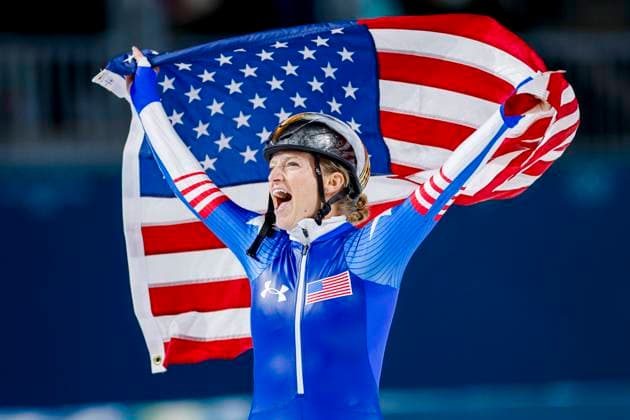 Mia Manganello of United States of America celebrating and holding flag after Women s Mass Start Final, Milano Cortina 2026 Winter Olympics: Day 15, Speed skating, Eisschnelllauf - Milano Cortina 2026 Winter Olympics: Day 15, Milano Speed Skating Stadium, February 21, 2026, Milan, Italy.
