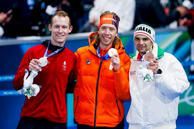 second Viktor Hald Thorup of Denmark and winner Jorrit Bergsma of the Netherlands and third Andrea Giovannini of Italy smiling during the medal ceremony after Men s Mass Start Final, Milano Cortina 2026 Winter Olympics: Day 15, Speed skating, Eisschnelllauf - Milano Cortina 2026 Winter Olympics: Day 15, Milano Speed Skating Stadium, February 21, 2026, Milan, Italy.