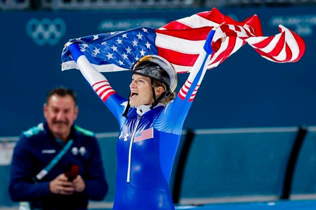 Mia Manganello of United States of America celebrating and holding flag after Women s Mass Start Final, Milano Cortina 2026 Winter Olympics: Day 15, Speed skating, Eisschnelllauf - Milano Cortina 2026 Winter Olympics: Day 15, Milano Speed Skating Stadium, February 21, 2026, Milan, Italy.