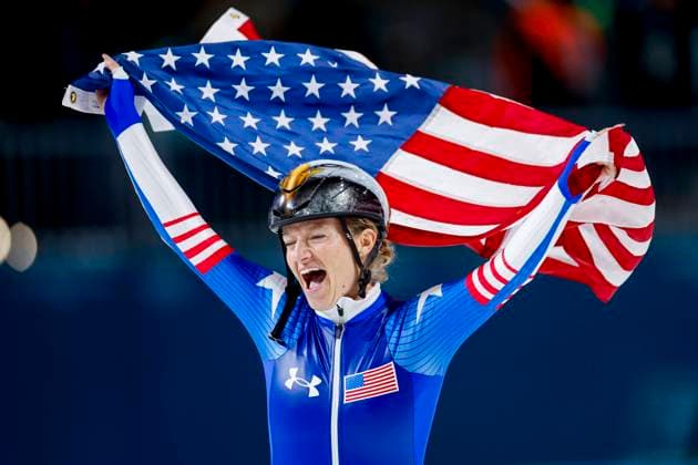 Mia Manganello of United States of America celebrating and holding flag after Women s Mass Start Final, Milano Cortina 2026 Winter Olympics: Day 15, Speed skating, Eisschnelllauf - Milano Cortina 2026 Winter Olympics: Day 15, Milano Speed Skating Stadium, February 21, 2026, Milan, Italy.