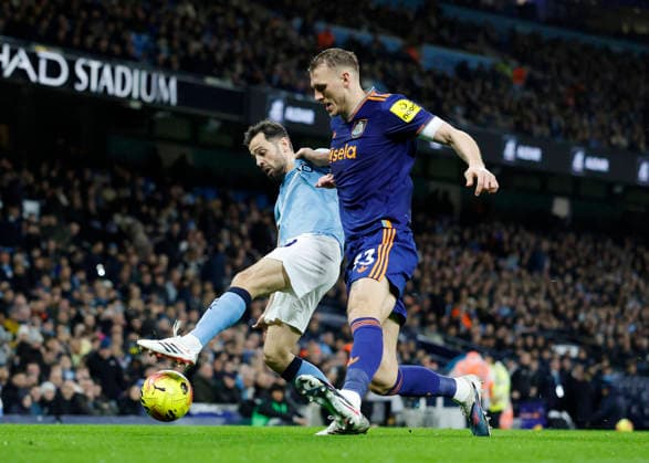 Manchester, England, 21st February 2026. Bernardo Silva of Manchester City (l) tussles with Dan Burn of Newcastle United (r) during the Manchester City vs Newcastle United Premier League match at the Etihad Stadium, Manchester. Picture credit should read: Cody Froggatt Sportimage EDITORIAL USE ONLY. No use with unauthorised audio, video, data, fixture lists, club league logos or live services. Online in-match use limited to 120 images, no video emulation. No use in betting, games or single club league player publications. SPI_012_CF_Man_City_Newc SPI-4542-0012