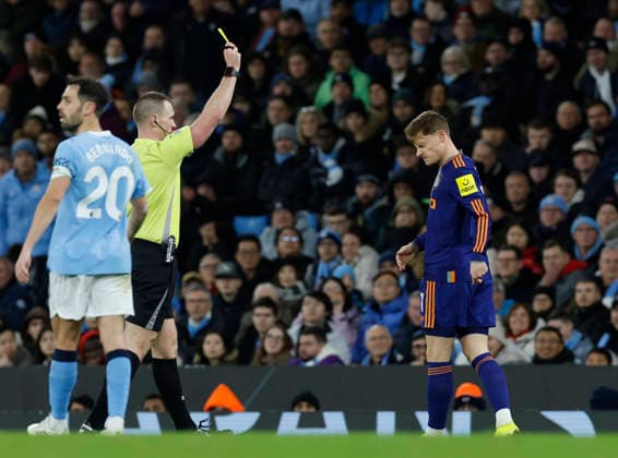Manchester, England, 21st February 2026. Referee Thomas Bramall issues a yellow card to Harvey Barnes of Newcastle United during the Manchester City vs Newcastle United Premier League match at the Etihad Stadium, Manchester. Picture credit should read: Cody Froggatt Sportimage EDITORIAL USE ONLY. No use with unauthorised audio, video, data, fixture lists, club league logos or live services. Online in-match use limited to 120 images, no video emulation. No use in betting, games or single club league player publications. SPI_063_CF_Man_City_Newc SPI-4542-0063