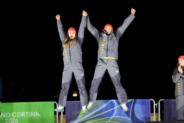 (260222) -- CORTINA D AMPEZZO, Feb. 22, 2026 -- Silver medalists Lisa Buckwitz (L) Neele Schuten of Germany jump on the podium during the awarding ceremony for the Bobsleigh 2-woman at the 2026 Milan-Cortina Winter Olympics in Cortina, Italy, Feb. 21, 2026. ) (MICO2026)ITALY-CORTINA D AMPEZZO-OLYMPIC Winter games, Winterspiele,Spiele, Summer games BOBSLEIGH-2-WOMAN DingxXu 